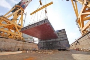 The keel section being lowered into the dock