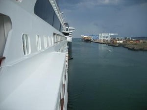 One can just see the QM2 sticking out from behind the Veendam and in the distance the MSC Stella at the container terminal